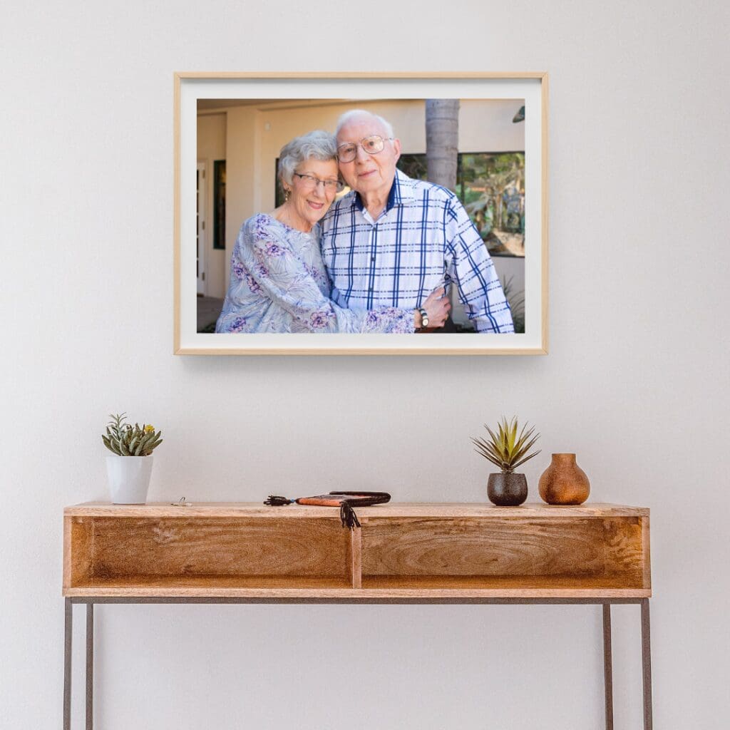 framed portrait of older married couple displayed over a table