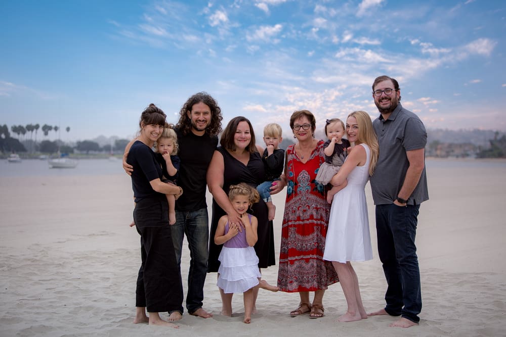 extended family with kids and grandma and parents on the beach